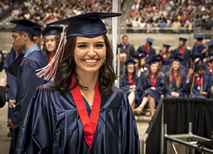 Female graduate smiles at camera